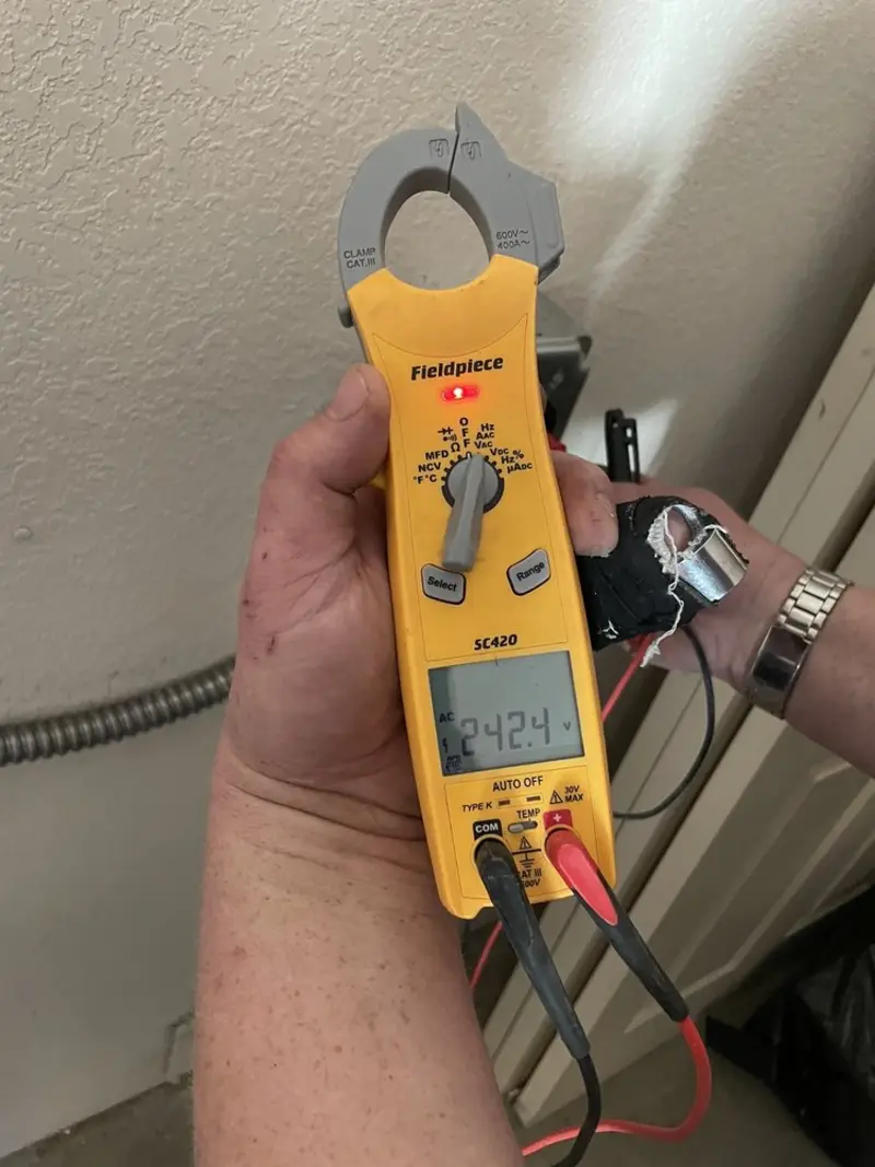 Voltage testing with clamp meter during Outlet Installation in Fulton